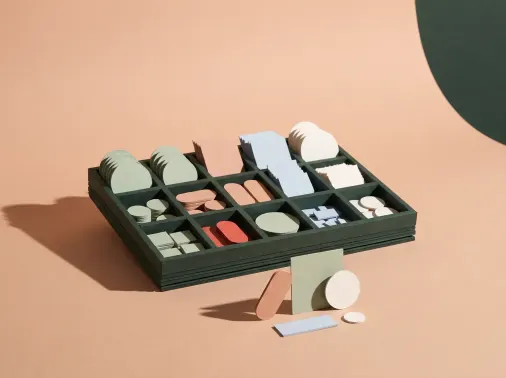 Design System: Ein Setzkasten aus Karton mit sortierten Papierbausteinen, davor ein kleines zusammengesetztes Layout